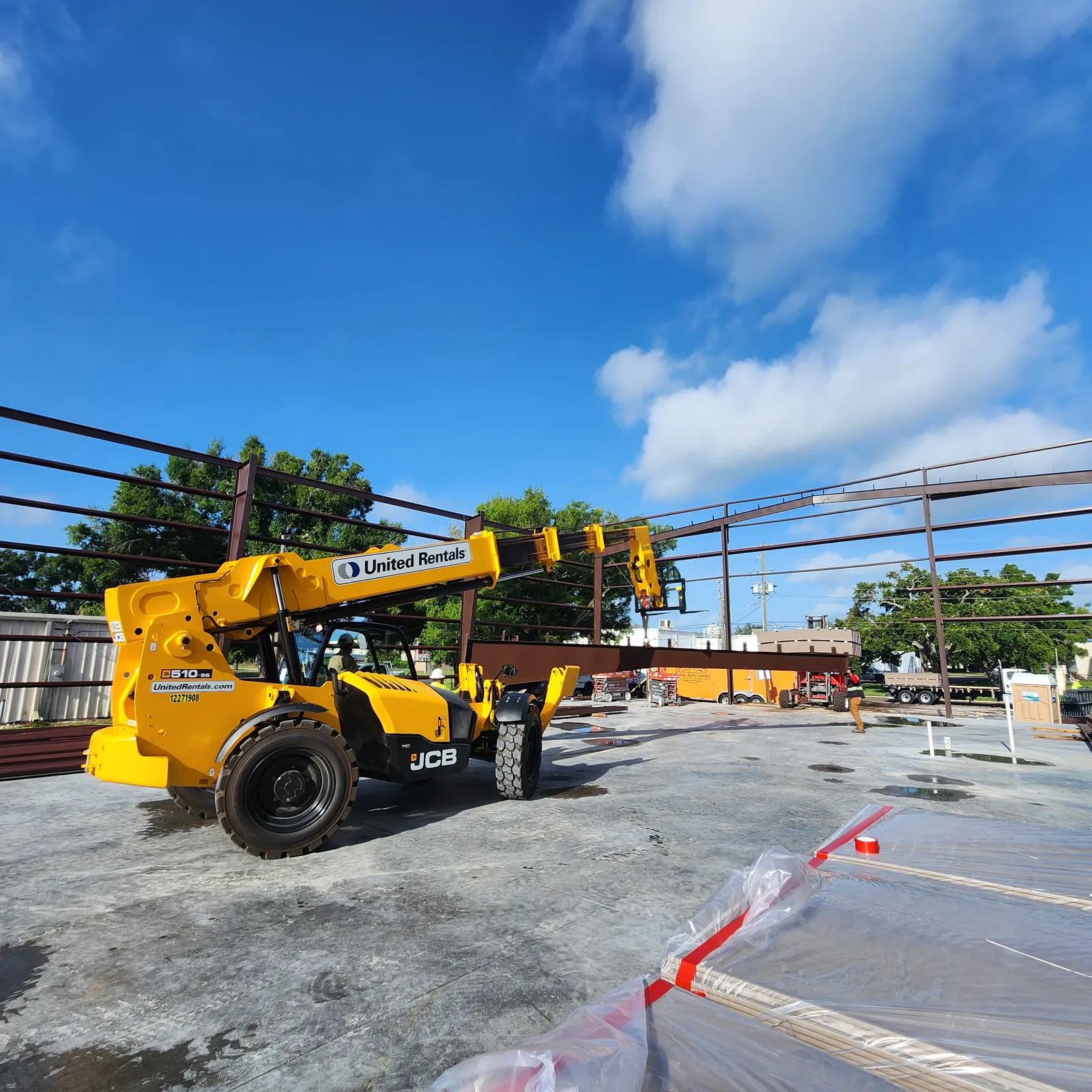 Steel frame structure taking shape with construction equipment on site