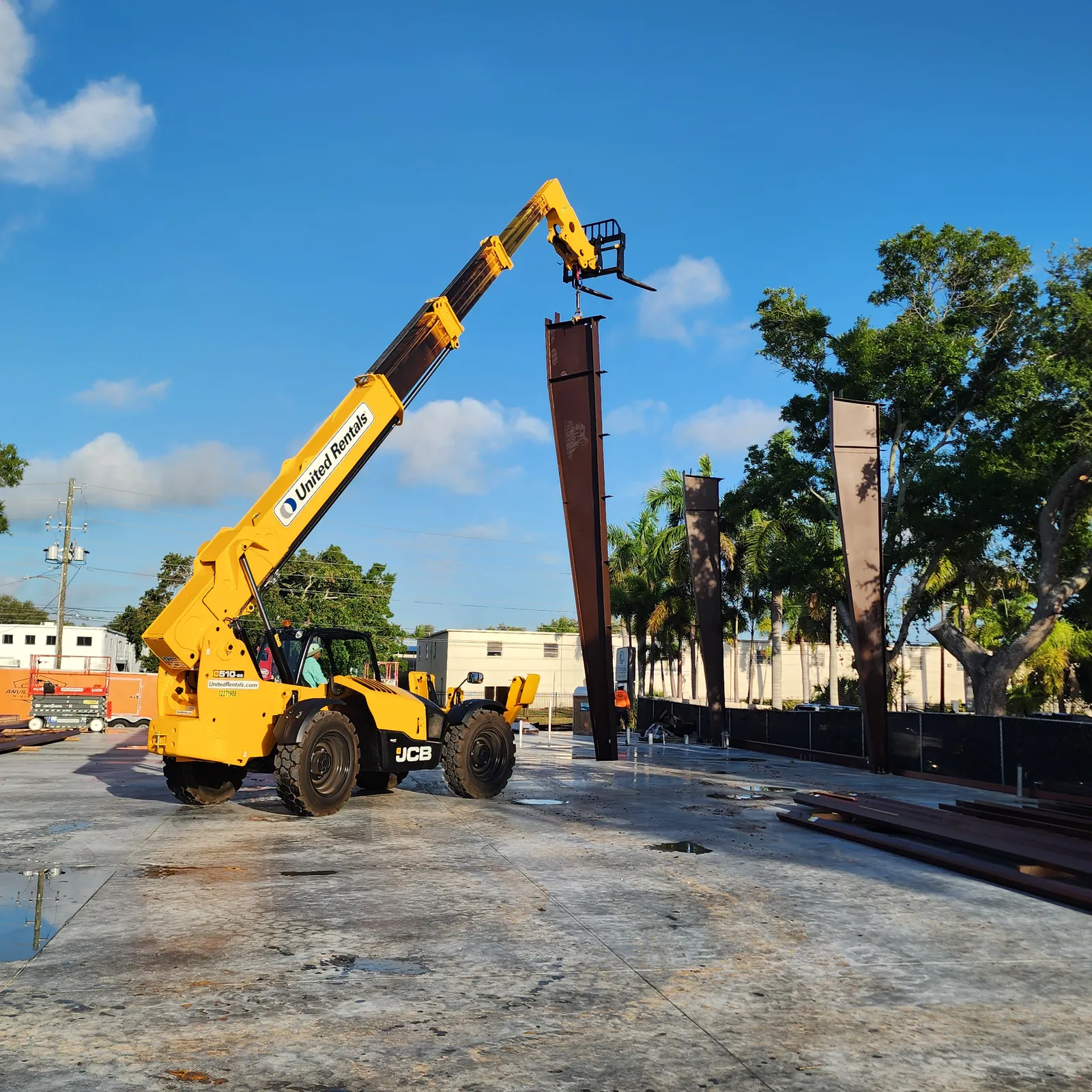 Telehandler working alongside the steel building structure